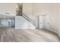 Open living room showcasing a modern staircase and wood-look floors at 491 Kristin Ln, Henderson, NV 89011