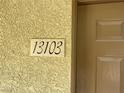 Close-up of the building's address marker at 50 Aura De Blanco St # 13103, Henderson, NV 89074