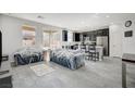 Open living room with dark kitchen cabinets and gray tile floors at 6201 Ashley Hills Ave, Las Vegas, NV 89141