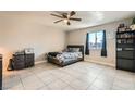 Comfortable bedroom with a queen-size bed and tile flooring at 6381 W Washington Ave, Las Vegas, NV 89107