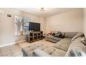 Bright living room with a sectional sofa and flat-screen TV at 6381 W Washington Ave, Las Vegas, NV 89107