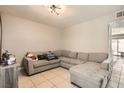 Spacious living room featuring a sectional sofa and tile floors at 6381 W Washington Ave, Las Vegas, NV 89107