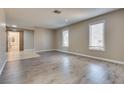 Living room featuring gray laminate flooring and neutral walls at 6725 Carrera Dr, Las Vegas, NV 89103