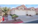 Attractive two-unit stucco home with double garage and mature landscaping at 7925 Settlers Ridge Ln, Las Vegas, NV 89145