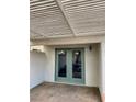 Covered patio with teal doors leading to the backyard at 8101 Spur Ct, Las Vegas, NV 89145