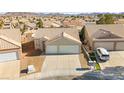 Two-car garage home with a front yard, aerial view at 861 Zinnia Cir, Henderson, NV 89015