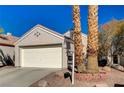 House exterior with a white garage door and brick landscaping at 9612 World Cup Dr, Las Vegas, NV 89117