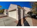 House exterior showcasing a white garage door and walkway at 9612 World Cup Dr, Las Vegas, NV 89117