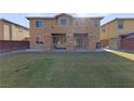 Large backyard with grassy lawn, covered patio, and storage shed at 10350 Blue Ginger Dr, Las Vegas, NV 89135