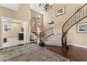 Grand entryway with curved staircase and hardwood floors at 10825 Bernini Dr, Las Vegas, NV 89141