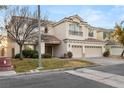 Two-story house with three-car garage and landscaping at 10825 Bernini Dr, Las Vegas, NV 89141