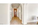 Light and bright entryway with wood-look floors and an arched doorway at 1234 Calcione Dr, Henderson, NV 89011
