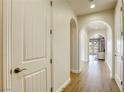 Long hallway with light walls and wood-look floors at 1234 Calcione Dr, Henderson, NV 89011