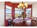 Round dining table with seating for four and red walls at 2755 Sunken Ship St, Laughlin, NV 89029