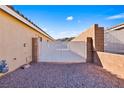View of the side yard with a white metal gate at 2755 Sunken Ship St, Laughlin, NV 89029