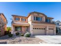 Two-story house with three-car garage and desert landscaping at 3107 Lenoir St, Las Vegas, NV 89135