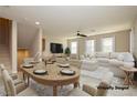 Virtually staged dining area with adjacent living space at 368 Gracious Way, Henderson, NV 89011