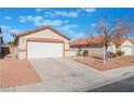 House exterior featuring a two-car garage and front yard at 402 Dune Ridge Ave, North Las Vegas, NV 89031