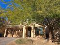 Two-story house with a three-car garage and mature trees at 6538 Creekside Cellars Ct, Las Vegas, NV 89139