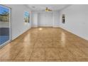 Large living area with tile flooring and access to the backyard at 7100 Estrella De Mar Ave, Las Vegas, NV 89131