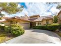 Well-maintained single Gathering home boasting a tile roof, two-car garage, and manicured landscaping at 7909 Rio Rico Dr, Las Vegas, NV 89113