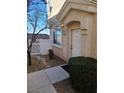 Front entrance with white door and small landscaped area at 8834 Duncan Barrel Ave # 103, Las Vegas, NV 89178