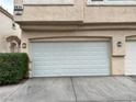 Spacious multi-car garage with white door and exterior lighting at 8834 Duncan Barrel Ave # 103, Las Vegas, NV 89178