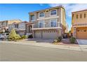 Two-story house with a three-car garage and landscaped front yard at 10166 Bishops Peak Ct, Las Vegas, NV 89141