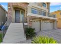 Two-story home's front entrance with stairs leading to the entryway at 10166 Bishops Peak Ct, Las Vegas, NV 89141