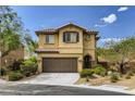 Two-story house with brown garage door and landscaping at 10489 Bolting Cloud Dr, Las Vegas, NV 89178