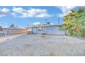 Ranch style home with gray exterior, white garage door, and landscaping at 1205 Sattes St, Las Vegas, NV 89101