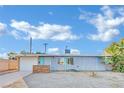 Ranch style home with gray exterior, white garage door, and landscaping at 1205 Sattes St, Las Vegas, NV 89101