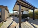 Relaxing backyard oasis with a pergola and stone pathway at 12422 Tudor Arch Dr, Las Vegas, NV 89138