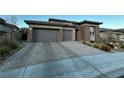 Two-story home with a three-car garage and paved driveway at 12422 Tudor Arch Dr, Las Vegas, NV 89138