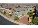 Aerial view of a two-story house with a gray roof and small backyard at 126 Ostinato Ln, Henderson, NV 89015