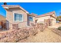 House with a stone wall and wrought iron fence at 1426 Radig Ct, Boulder City, NV 89005