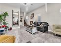 Spacious living room with gray tile floors and modern fireplace at 1992 Star Creek Bay Ln, Las Vegas, NV 89115