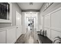 Light-filled hallway with hardwood floors and built-in bench at 2365 Boretto St, Henderson, NV 89044