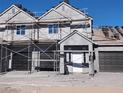 Exterior view of homes under construction featuring stucco and new roofing tiles at 380 Erin St, Pahrump, NV 89048