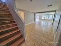 Open living area with tile floors and staircase at 4823 Jubilee Diamond Ct, Las Vegas, NV 89139