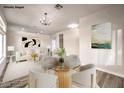 Bright dining area with a glass-top table and modern light fixture at 5306 Falling Petals Dr, North Las Vegas, NV 89031