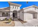 Front view of the house, featuring a walkway and two-car garage at 5306 Falling Petals Dr, North Las Vegas, NV 89031