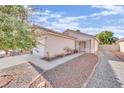 Front view of a house with a gravel pathway and desert landscaping at 5533 Ramirez St, North Las Vegas, NV 89031