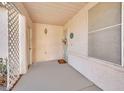 Covered front porch entry with a white door and lattice detail at 5533 Ramirez St, North Las Vegas, NV 89031