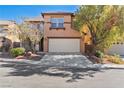 Charming two-story home featuring a two-car garage, a tiled roof, and drought tolerant landscaping at 5636 Granville Lake St, North Las Vegas, NV 89031