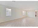 Spacious living room featuring tile floors and ample natural light from multiple windows at 5636 Granville Lake St, North Las Vegas, NV 89031