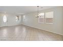 Bright living room with tile flooring, entry door, and a modern chandelier at 5636 Granville Lake St, North Las Vegas, NV 89031