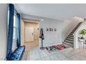 Bright and spacious entryway with tiled floors and staircase at 5658 Adobe Jack St, North Las Vegas, NV 89031