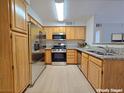 Well-equipped kitchen with stainless steel appliances and light wood cabinets at 5710 Tropicana Ave # 1063, Las Vegas, NV 89122