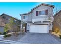 Two-story house with gray siding, white garage door, and landscaping at 5921 Roaring Canyon Ct, Las Vegas, NV 89139